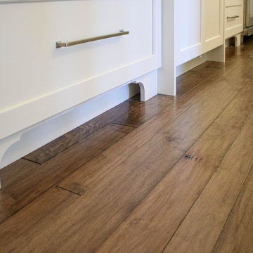 White Kitchen with Gray Quartz Countertops, Farmhouse Sink and Hardwood Floors