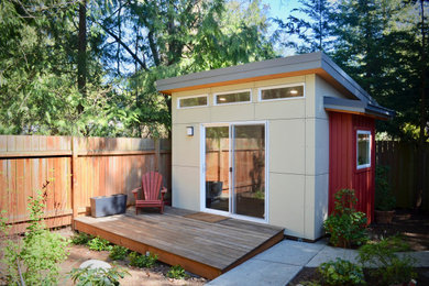 Example of a small minimalist freestanding desk laminate floor and brown floor home studio design in Seattle with white walls