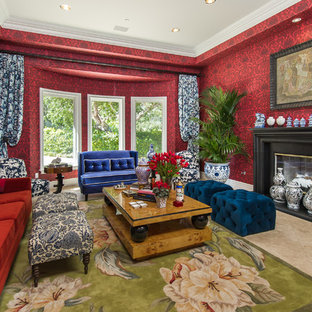 Inspiration for a mediterranean formal living room in Los Angeles with red walls, a standard fireplace and beige floors.