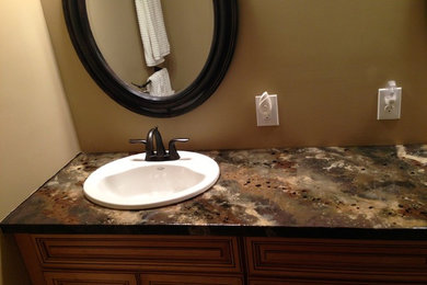 Inspiration for a mid-sized timeless master bathroom remodel in Indianapolis with a drop-in sink, raised-panel cabinets, medium tone wood cabinets, concrete countertops and beige walls