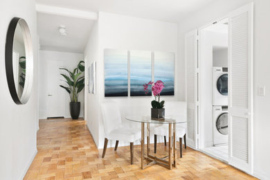 Inspiration for a mid-sized transitional light wood floor and beige floor enclosed dining room remodel in New York with white walls and no fireplace