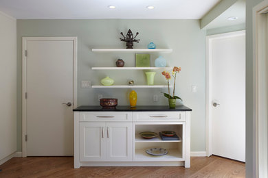 Large trendy l-shaped medium tone wood floor and brown floor eat-in kitchen photo in San Francisco with an undermount sink, shaker cabinets, white cabinets, white backsplash, subway tile backsplash, stainless steel appliances and an island