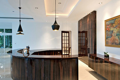 Example of a large trendy u-shaped marble floor and beige floor eat-in kitchen design in Tampa with flat-panel cabinets, dark wood cabinets, granite countertops, stainless steel appliances and an island