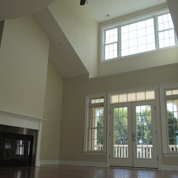 Two Story Living Room With Vaulted Ceilings And Entry Onto Rear Deck