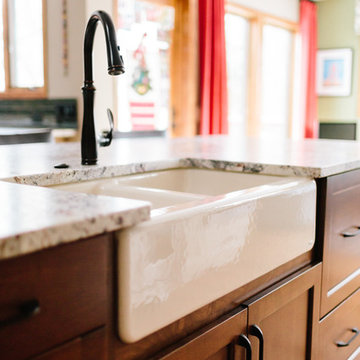 White Farmhouse Sink with Stained Maple Cabinets