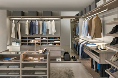 Inspiration for a large contemporary gender-neutral walk-in closet remodel in Orange County with light wood cabinets