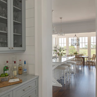 Large beach style kitchen pantry remodeling - Large coastal dark wood floor and brown floor kitchen pantry photo in Charleston with gray cabinets, marble countertops, white backsplash, wood backsplash and an island