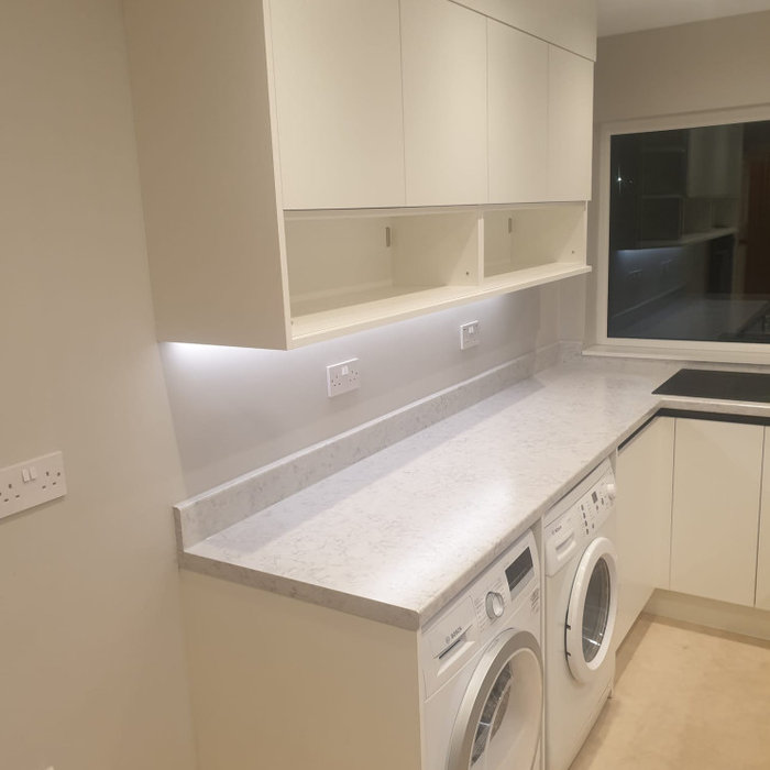 Kitchen - small contemporary kitchen idea in West Midlands with laminate countertops and white countertops