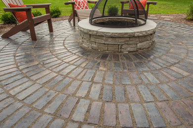Inspiration for a mid-sized rustic backyard concrete paver patio remodel in Indianapolis with a fire pit