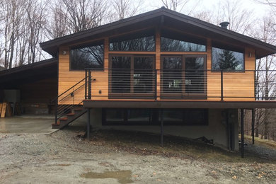 Trendy two-story wood house exterior photo in Burlington