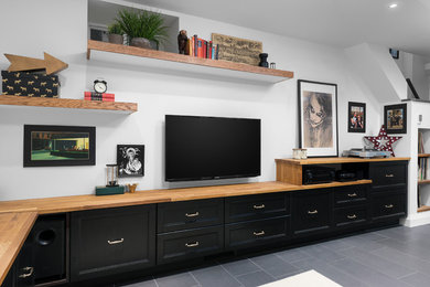 Inspiration for a mid-sized transitional look-out porcelain tile and gray floor basement remodel in Toronto with white walls