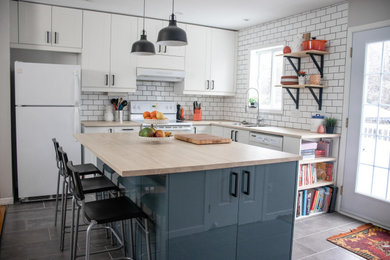 Eat-in kitchen - mid-sized farmhouse l-shaped porcelain tile and gray floor eat-in kitchen idea in Montreal with a double-bowl sink, shaker cabinets, white cabinets, laminate countertops, white backsplash, subway tile backsplash, white appliances, an island and beige countertops