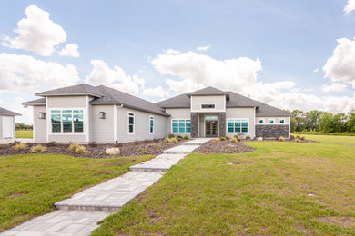 Transitional gray one-story exterior home idea in Other with a black roof