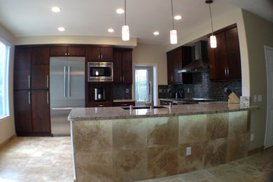 Kitchen - mid-sized transitional kitchen idea in San Diego with an undermount sink, flat-panel cabinets, dark wood cabinets, granite countertops, multicolored backsplash, matchstick tile backsplash, stainless steel appliances and no island