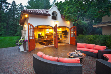 Inspiration for a large mediterranean backyard patio in Cincinnati with a fire feature and no cover.