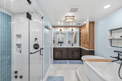 Example of a large master double-sink freestanding bathtub design in DC Metro with blue walls