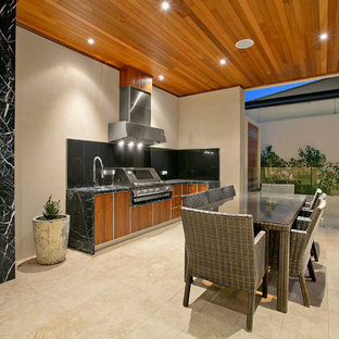 This is an example of a contemporary patio in Melbourne with an outdoor kitchen, tile and a roof extension.