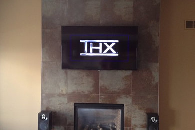 Example of a mid-sized minimalist dark wood floor and brown floor living room design in Other with brown walls, a standard fireplace, a tile fireplace and a wall-mounted tv