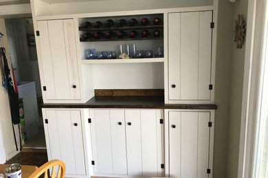 Inspiration for a coastal single-wall dry bar remodel in Boston with white cabinets, wood countertops, blue backsplash and brown countertops
