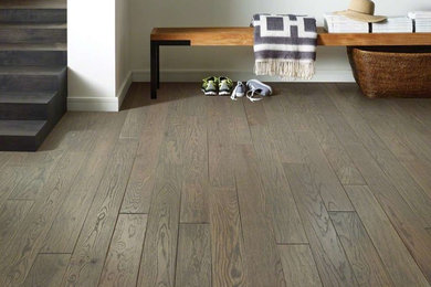 Example of a trendy dark wood floor and brown floor hallway design in Orange County with white walls