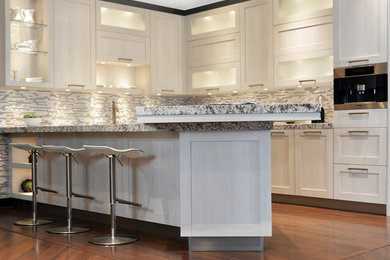 Example of a minimalist kitchen design in Portland with white cabinets