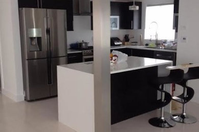 Example of a small trendy l-shaped porcelain tile and beige floor open concept kitchen design in New York with an undermount sink, flat-panel cabinets, dark wood cabinets, quartzite countertops, stainless steel appliances and an island