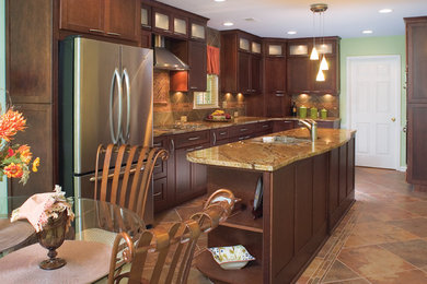 This is an example of a small contemporary galley eat-in kitchen in Atlanta with an undermount sink, flat-panel cabinets, dark wood cabinets, granite benchtops, multi-coloured splashback, stainless steel appliances, slate floors and with island.