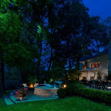 Mercury vapor light fixtures provide moon lighting. Bluestone terrace with wate