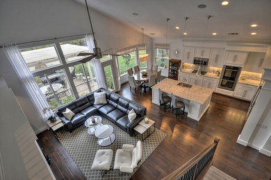 Example of a large trendy l-shaped dark wood floor eat-in kitchen design in Sacramento with a single-bowl sink, recessed-panel cabinets, white cabinets, granite countertops, white backsplash, stainless steel appliances and an island