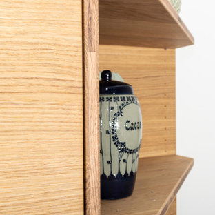 Huge contemporary kitchen pantry pictures - Inspiration for a huge contemporary u-shaped gray floor kitchen pantry remodel in Bremen with a drop-in sink, flat-panel cabinets, light wood cabinets, granite countertops, no island and black countertops