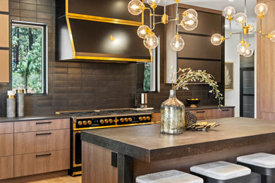 Huge minimalist light wood floor eat-in kitchen photo in Other with an undermount sink, flat-panel cabinets, medium tone wood cabinets, solid surface countertops, black backsplash, ceramic backsplash, black appliances, an island and brown countertops