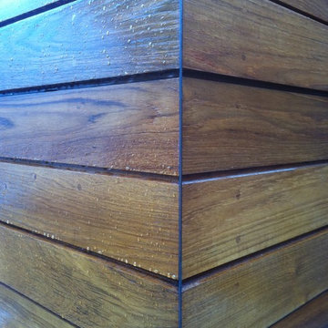 Teak siding, copper corners, plugged fastners
