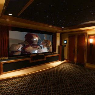 This is an example of a small classic enclosed home cinema in Baltimore with yellow walls, carpet and a projector screen.