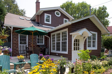 Small arts and crafts brown exterior home photo in Other