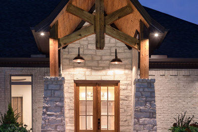 Large rustic white one-story brick exterior home idea in Little Rock with a shingle roof