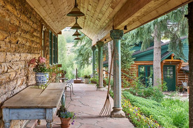 Mountain style porch photo in Denver with a roof extension