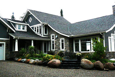 Large arts and crafts gray two-story wood exterior home photo in Toronto