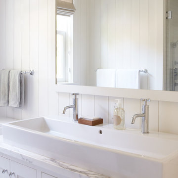 White bathroom with trough sink for two