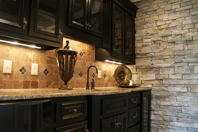 Inspiration for a mid-sized timeless single-wall enclosed kitchen remodel in Other with an undermount sink, glass-front cabinets, black cabinets, granite countertops, orange backsplash and stone tile backsplash