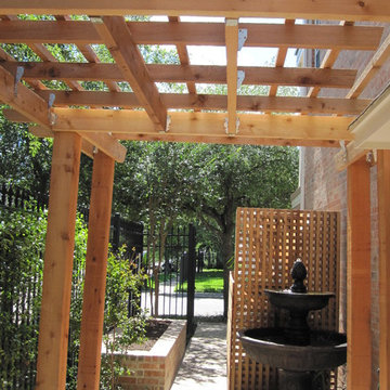 High function in a small side yard! Pergola, raised bed, mirrored wall, fountain