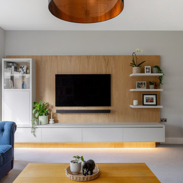 LUXURY FULLY FITTED LIVING ROOM WITH BESPOKE BOOKCASES AND MEDIA WALL