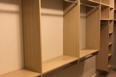 Large minimalist gender-neutral walk-in closet photo in Other