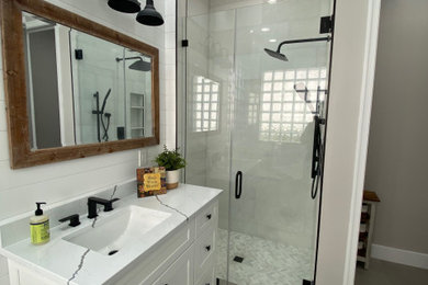 Freestanding bathtub - farmhouse master porcelain tile, gray floor, single-sink and shiplap wall freestanding bathtub idea in Miami with flat-panel cabinets, white cabinets, marble countertops, white countertops and a freestanding vanity