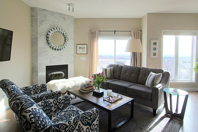 Inspiration for a mid-sized transitional open concept medium tone wood floor and brown floor family room remodel in Calgary with beige walls, a corner fireplace, a tile fireplace and a wall-mounted tv
