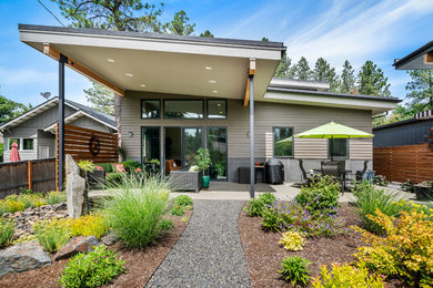 Photo of a large contemporary drought-tolerant and full sun backyard gravel landscaping in Other.