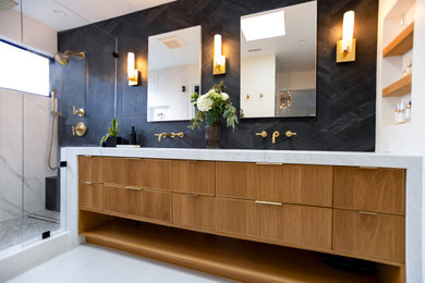 Inspiration for a mid-sized modern master black tile and porcelain tile porcelain tile, white floor, double-sink and wallpaper doorless shower remodel in Los Angeles with beaded inset cabinets, medium tone wood cabinets, a one-piece toilet, black walls, an undermount sink, quartz countertops, a hinged shower door, white countertops, a niche and a built-in vanity
