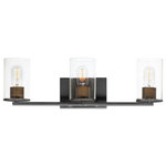 Maxim Lighting - Sleek 3-Light Bath Vanity - Cylinders in Clear Seedy glass on simple matte Black frames with Antique Brass socket covers. A clean and easily maintained fixture that easily coordinates with your stylish bathroom space.