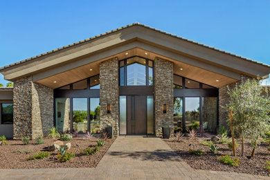 This is an example of a contemporary front door in Phoenix with a single front door and a dark wood front door.
