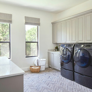 This is an example of an expansive classic separated utility room in Austin with a submerged sink, raised-panel cabinets, grey cabinets, engineered stone countertops, a side by side washer and dryer and white worktops.