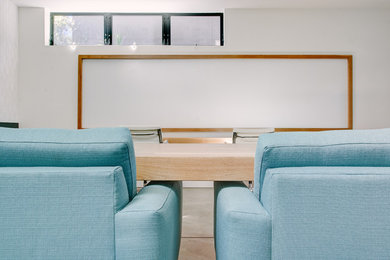 Inspiration for a mid-sized modern freestanding desk concrete floor study room remodel in Los Angeles with white walls